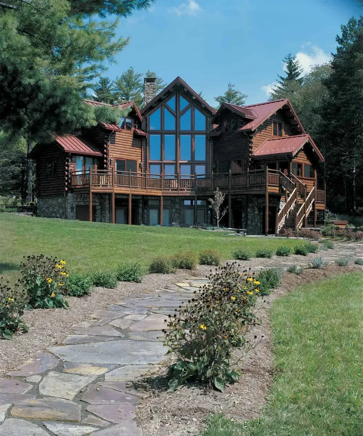 Exterior multi level custom cedar log home with full wall of glass. Contact Big Twig Homes LLC. for more details