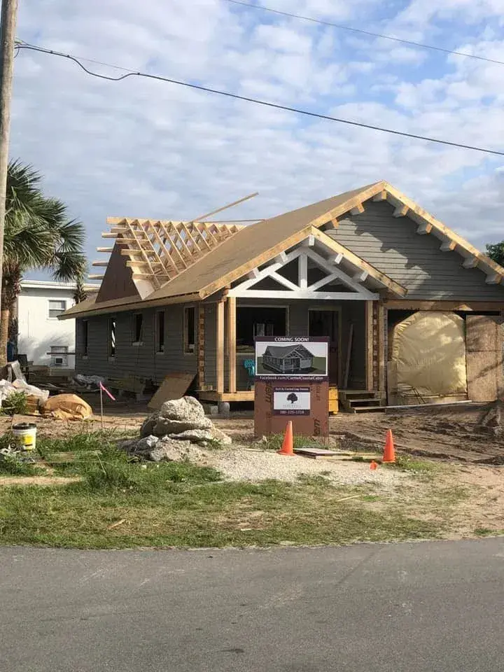 Cedar home exterior with roof framing complete