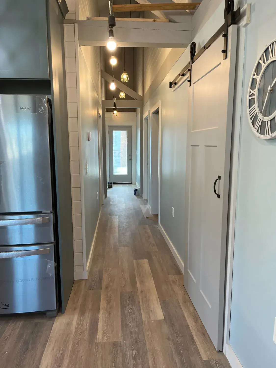 Hallway with barn door during finishing