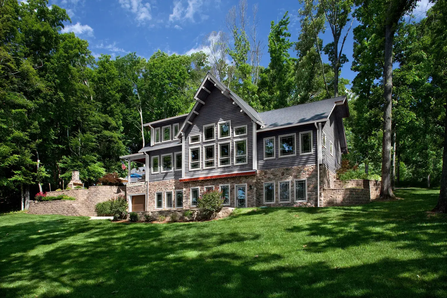 Rear view of a craftsman-style cedar home with walkout lower level