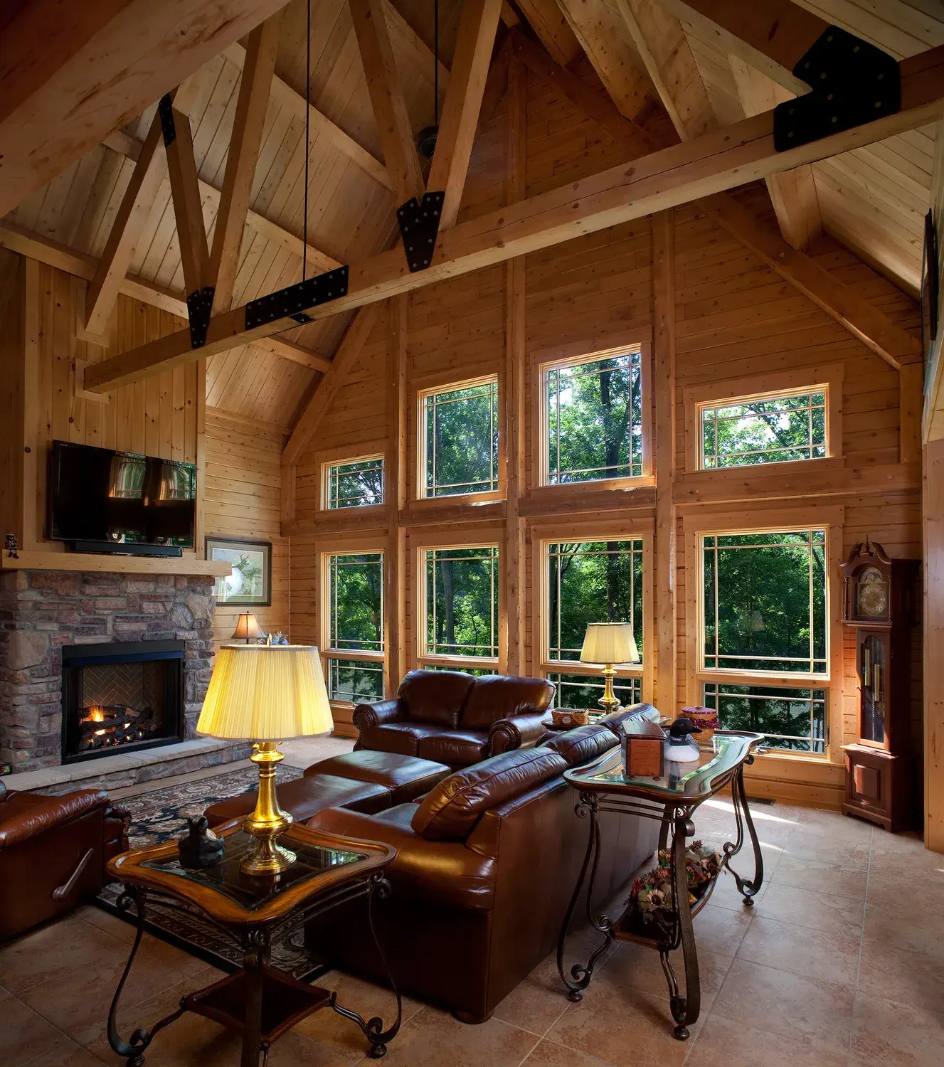 Cedar great room with timber trusses and a wall of windows