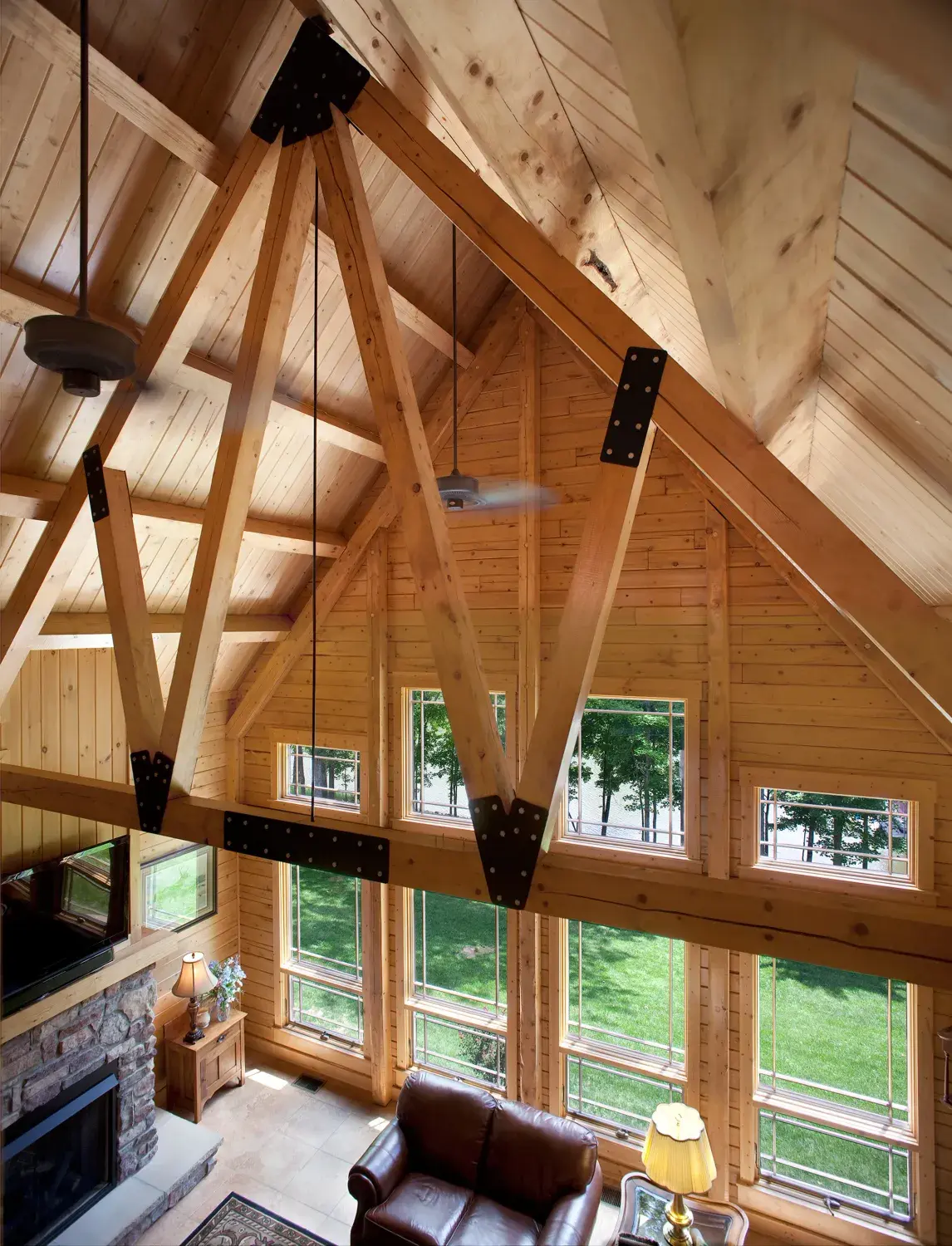 Timber trusses framing a tall gable wall of windows