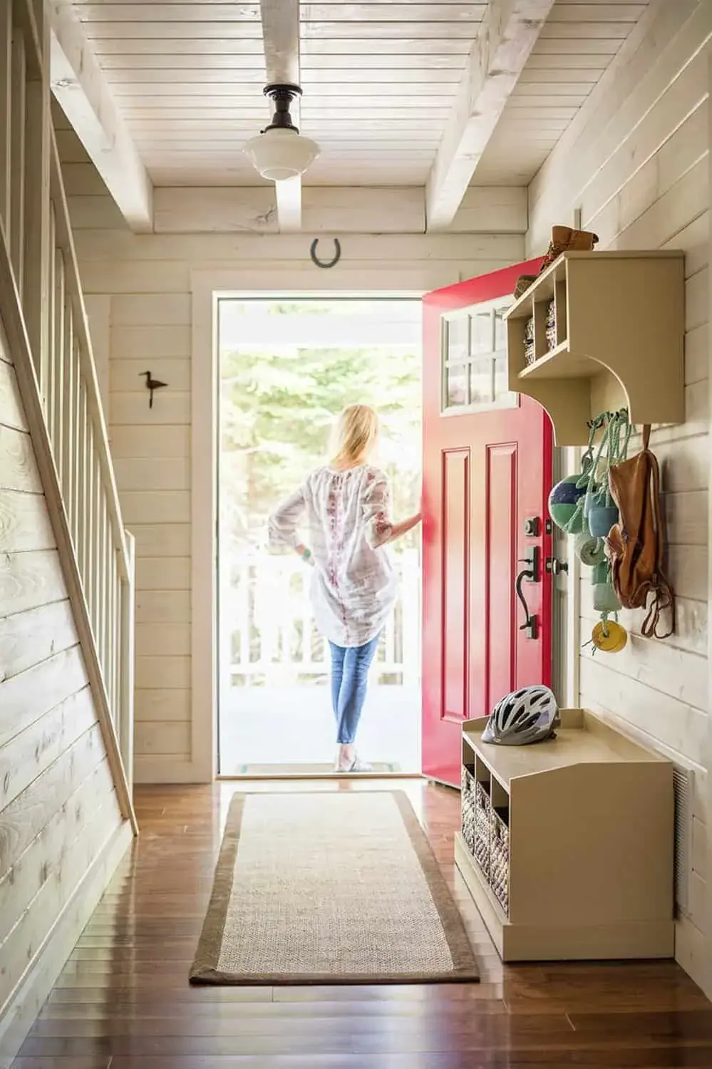 A woman standing in the doorway of her new home.