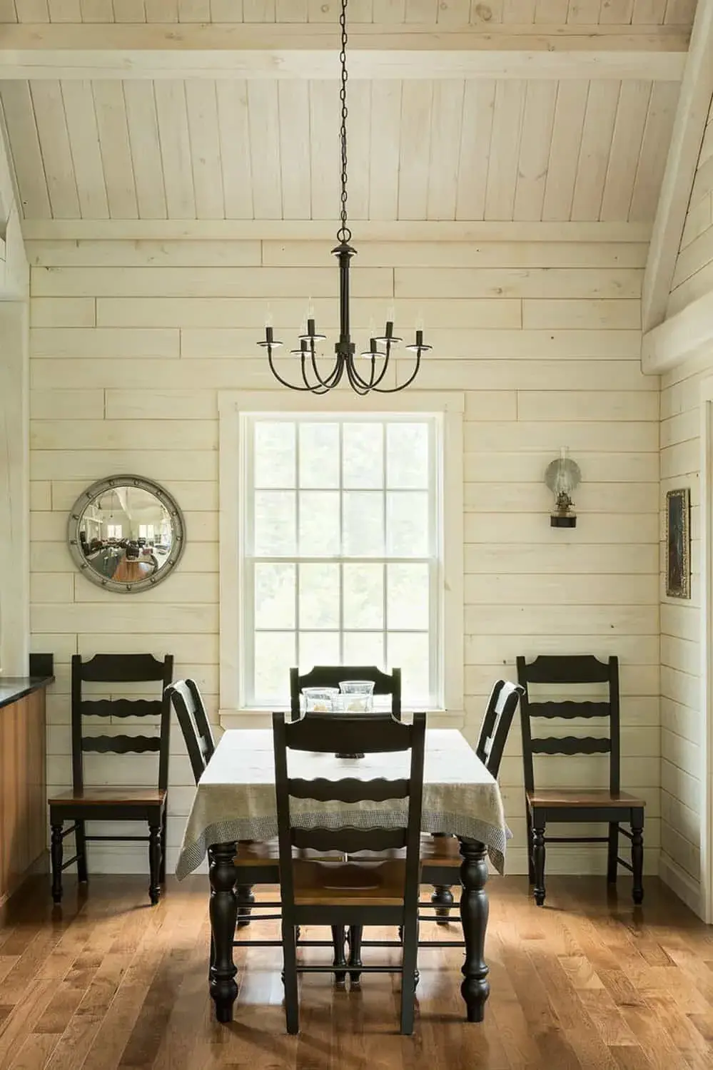 A modest chandelier over a dining table.