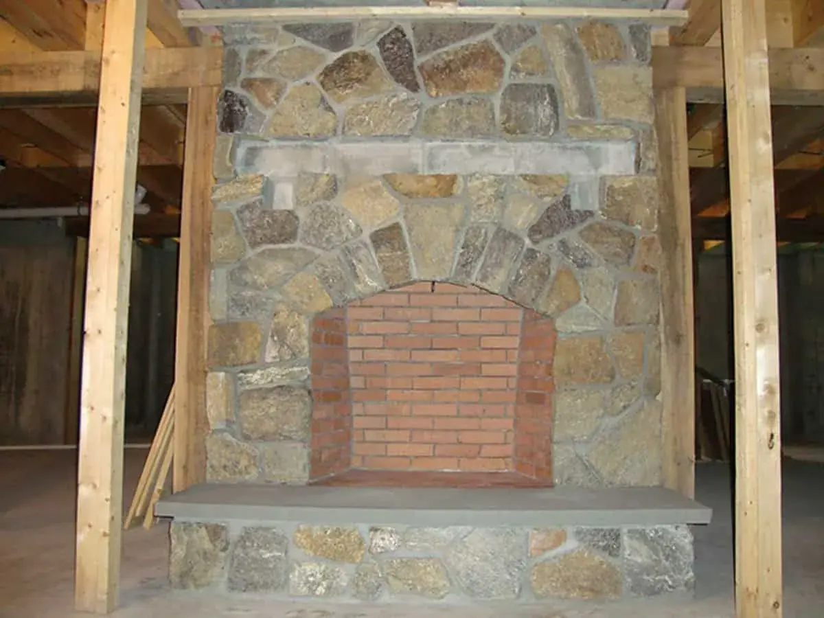 A beautiful stone fireplace in a home built by Big Twig Homes.
