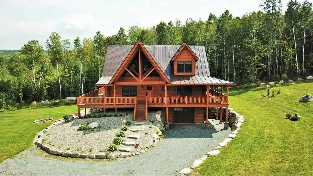 Cedar log home with a gabled porch from the Moosehead photo gallery