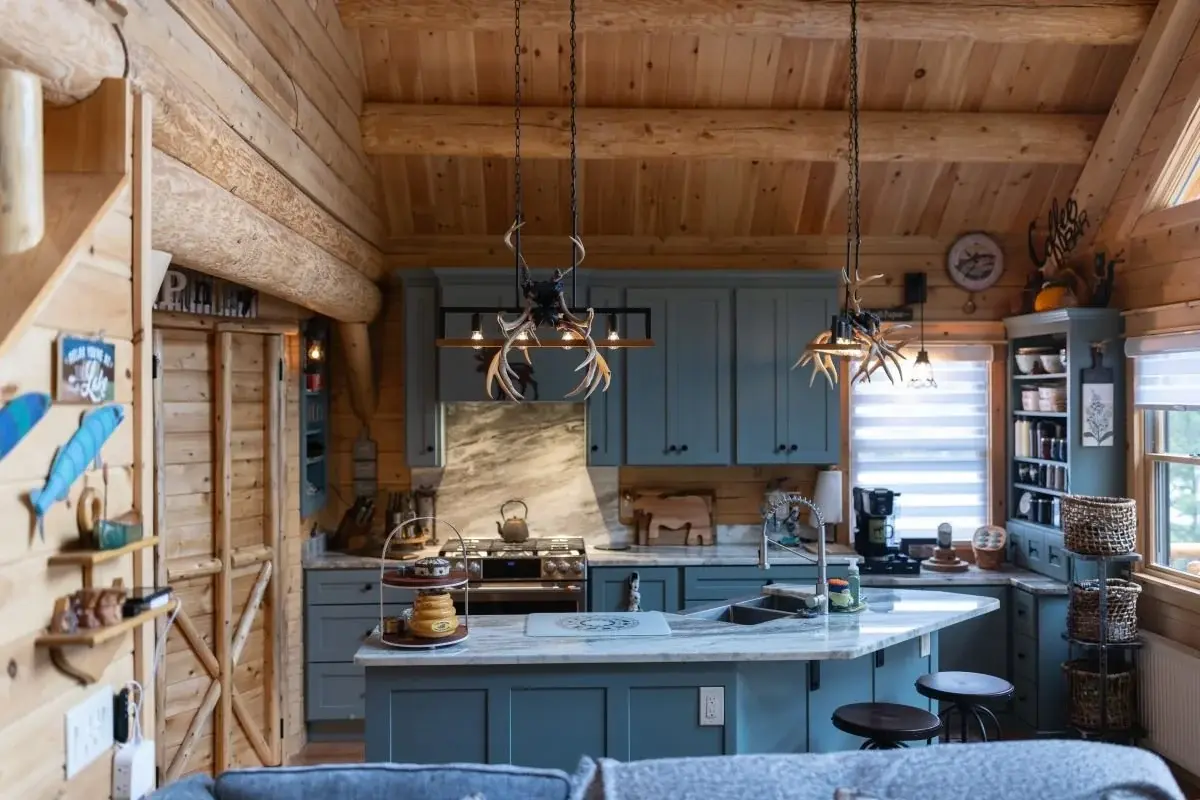 This compact kitchen makes the most of its square footage, and feels spacious thanks to a vaulted ceiling, striking pendant lights, and angled island bar. 