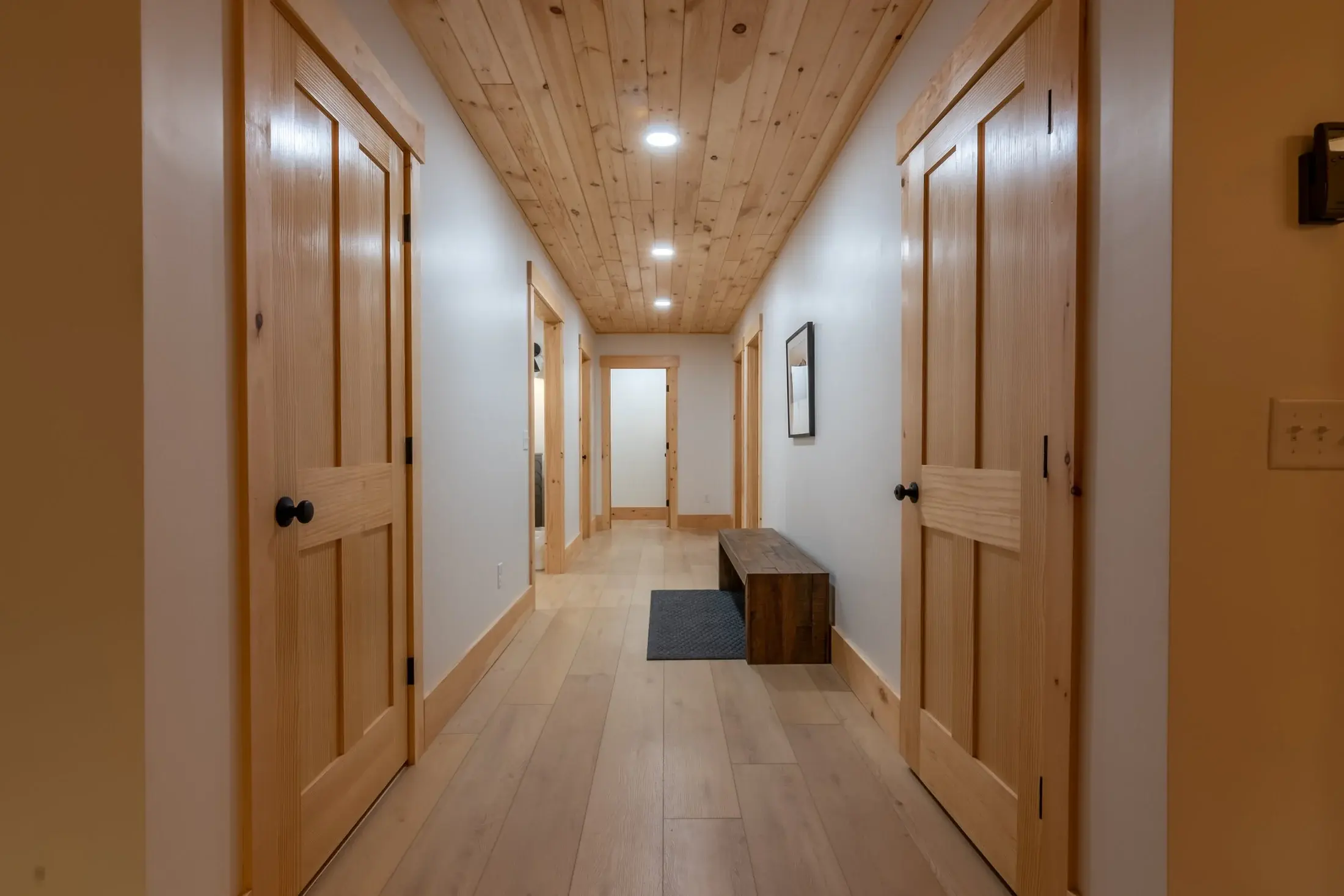 A wide, uncluttered hallway with plenty of light maintains the expansive, timeless feel of the home. 