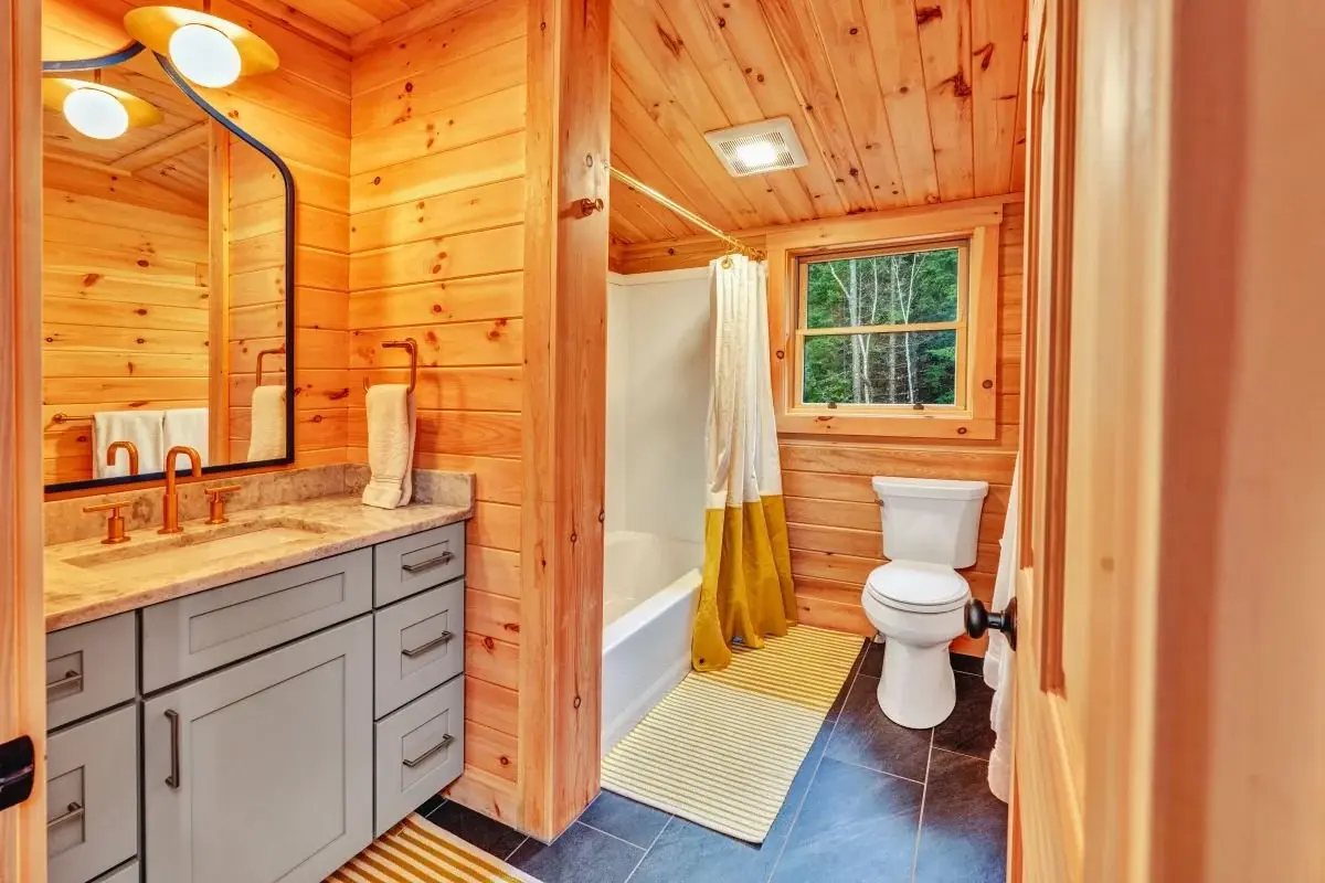The versatile layout of these bathrooms works for a standup shower downstairs and a full bathtub in the loft. Simple, square, double hung windows keep the room from feeling too busy, while letting in plenty of natural light. 