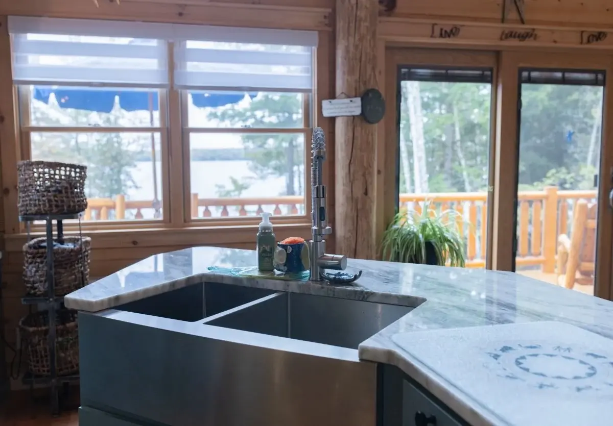 A deep sink in the island is easily accessible from the kitchen and living room, allowing flexibility and optimized flow. 