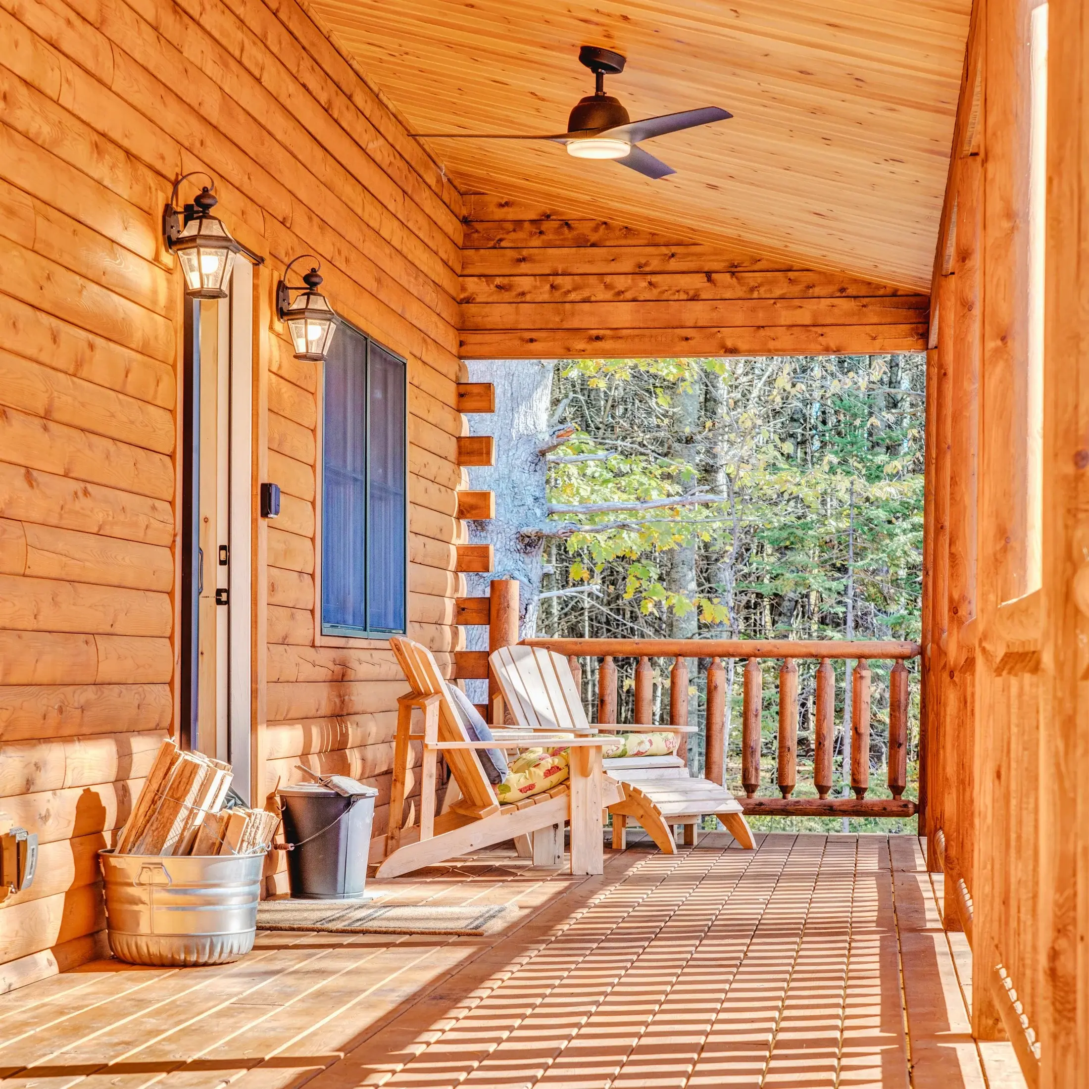 The covered porch serves as an entry and outdoor living space, with plenty of room for a pair of Adirondack chairs and a bundle of firewood. 