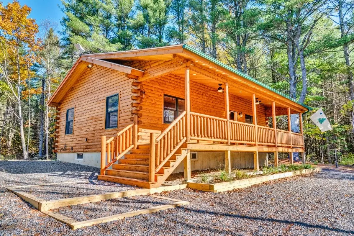 The Milo is a simple design, offering all the charm of log cabin living in a modest size. Here the wide steps and covered front porch make for an inviting entry and relaxing outdoor space. 