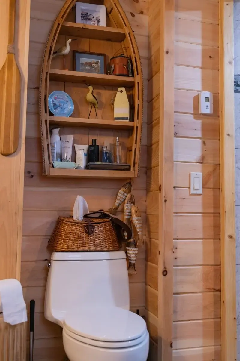 A subtle alcove is the perfect fit for shelving above the toilet. 