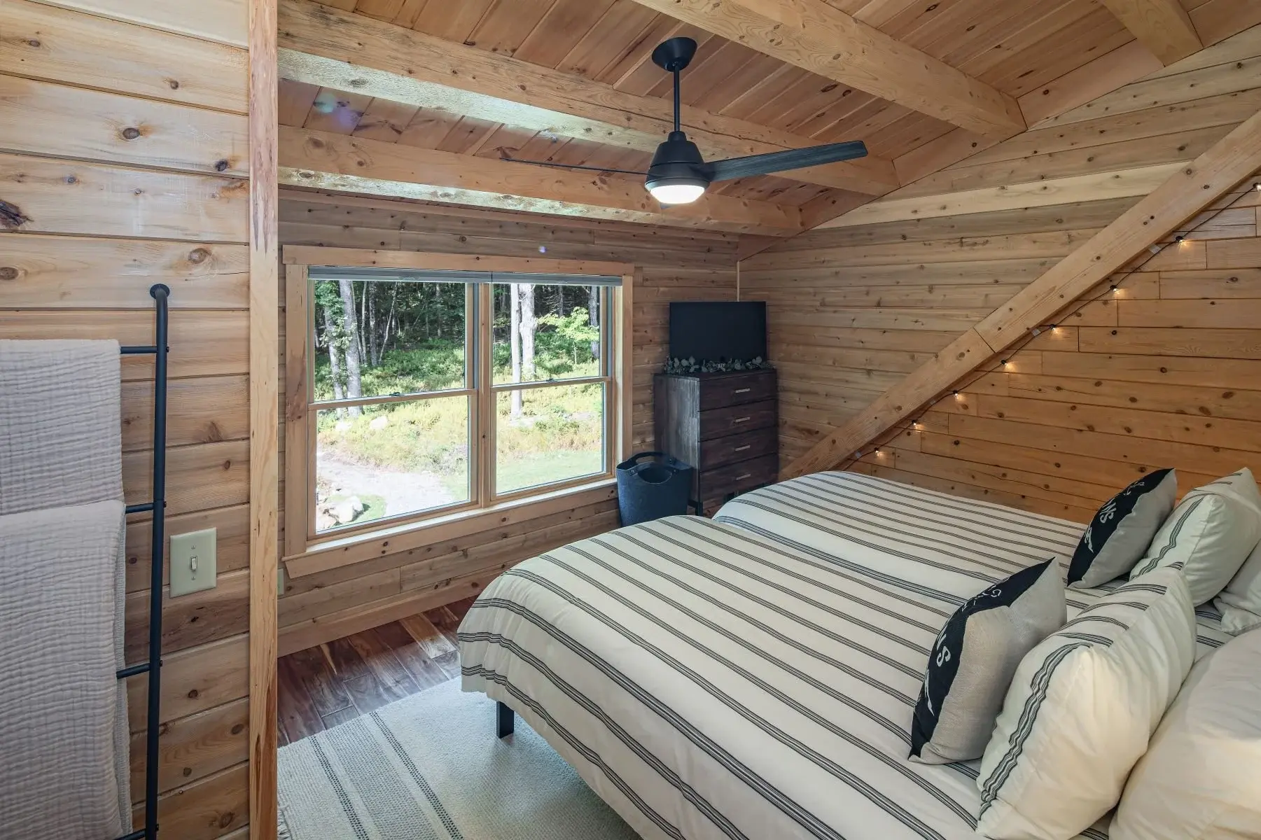 The second bedroom is tucked into the upstairs dormer, a great way to make the most of a lofted space. 