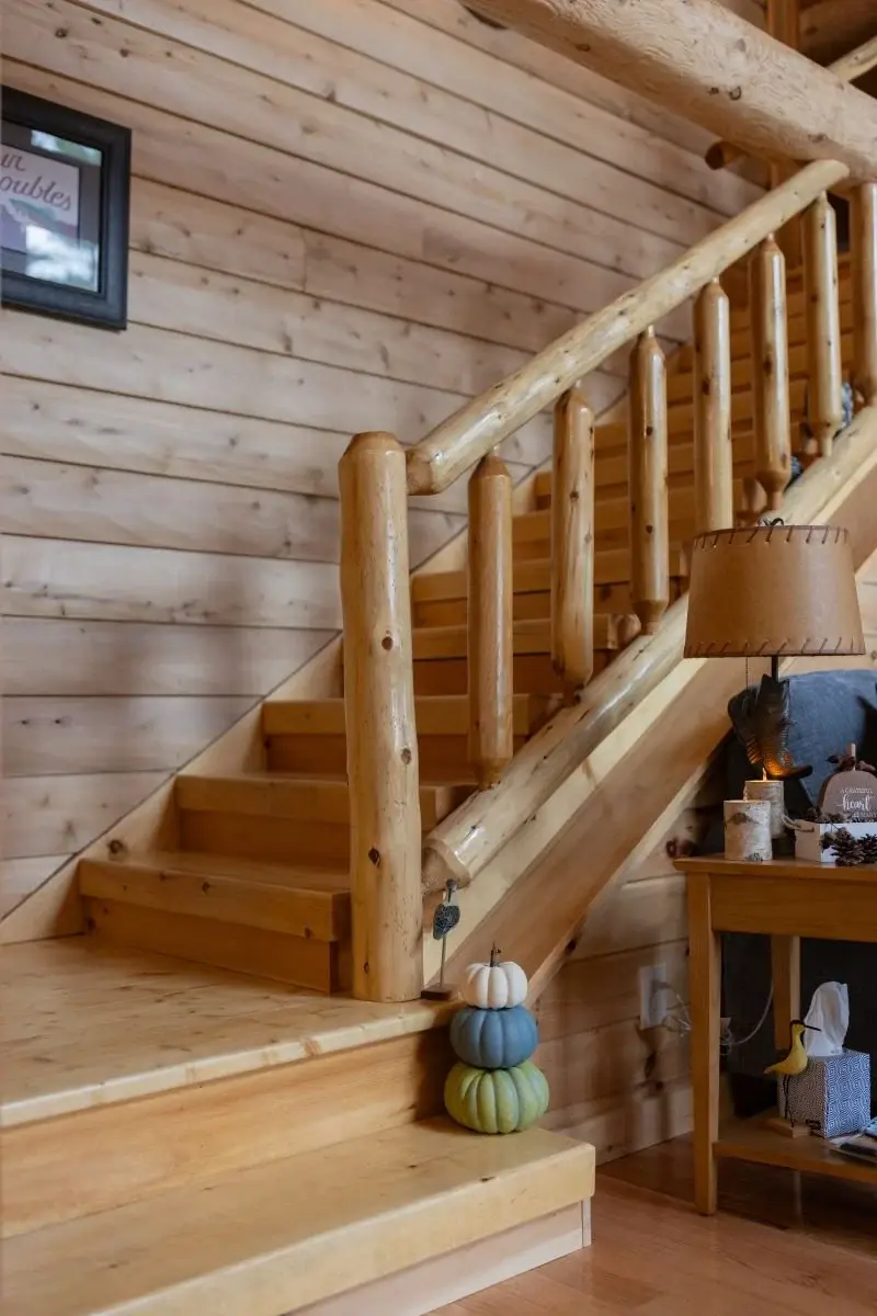 A wide landing, thick round balusters, and sturdy steps make this staircase feel warm and substantial. 