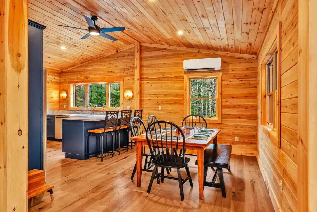 The open kitchen and dining room is tucked just beyond the main living room with versatile seating and an efficient layout. The spacious dining area fits a table large enough for entertaining, but bar seating in the kitchen is just right for a quick 