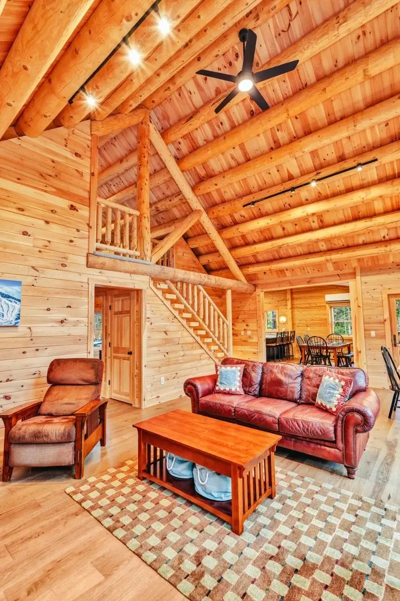 Exquisite craftsmanship highlights the natural beauty of Northern White Cedar logs. The stairs to the loft are situated along a sturdy log truss in the center of the home, and timeless leather furnishings and a natural fiber rug feel grounded beneath