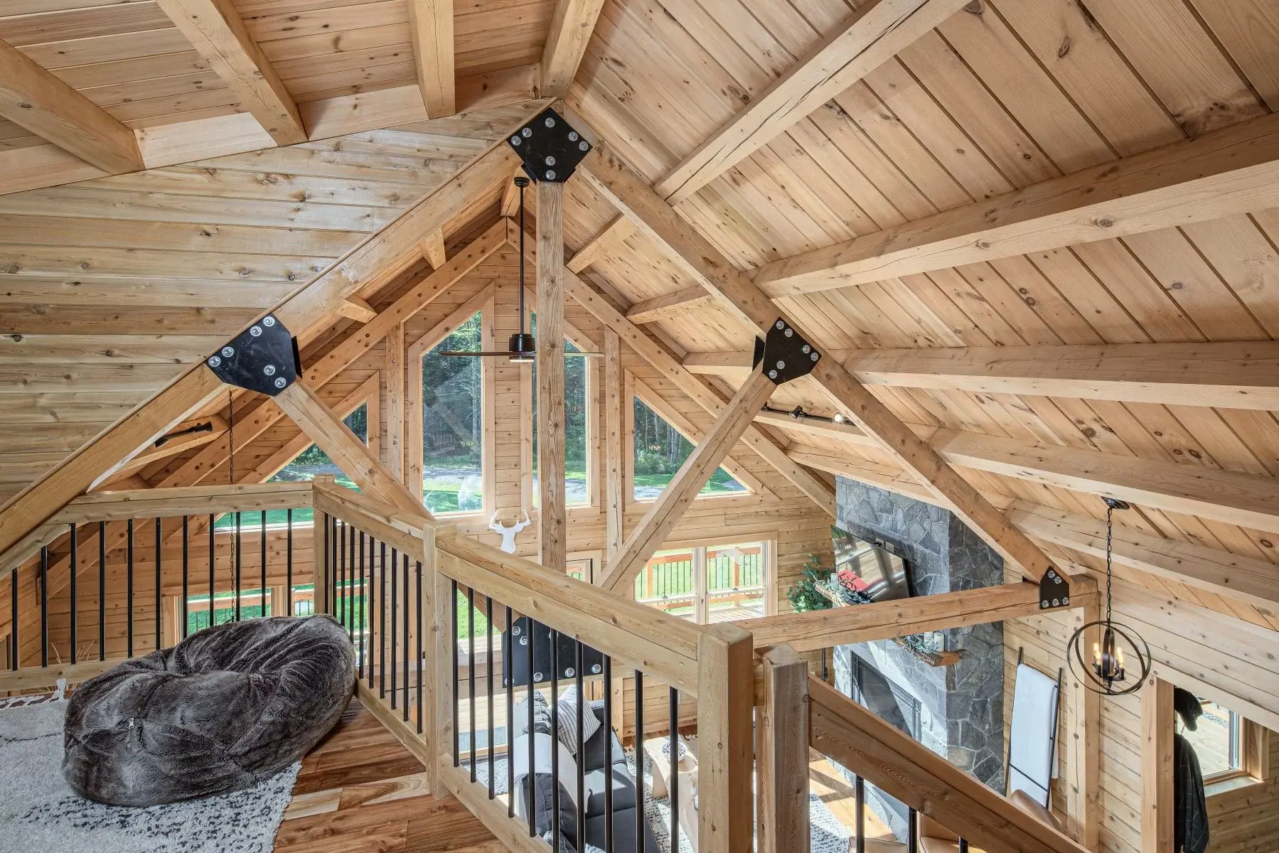 The loft offers a spectacular view of the craftsmanship and classic construction of a cedar log home. 