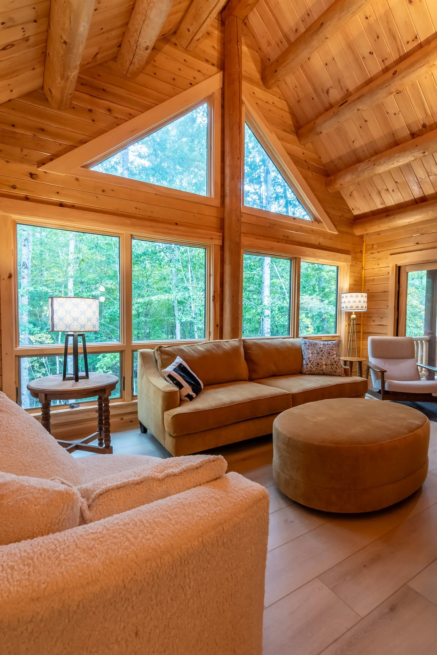 A separate sitting area serves as a calming repose from the main living space. A lower ceiling and three walls of windows defines the space while remaining connected to the great room. 