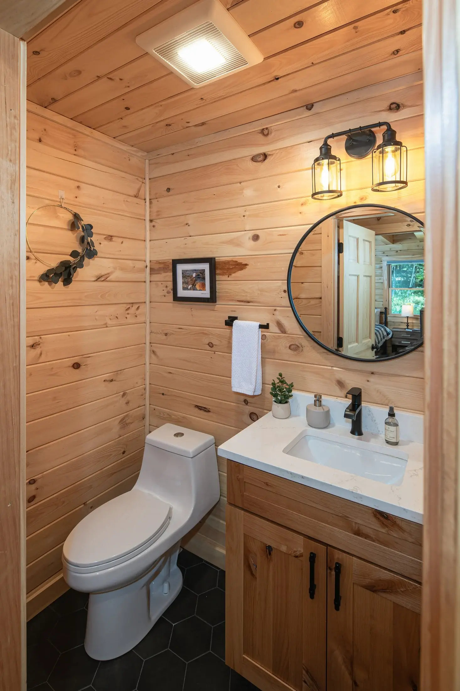 Industrial light fixtures and sturdy, black metal accents pair perfectly with natural cedar.