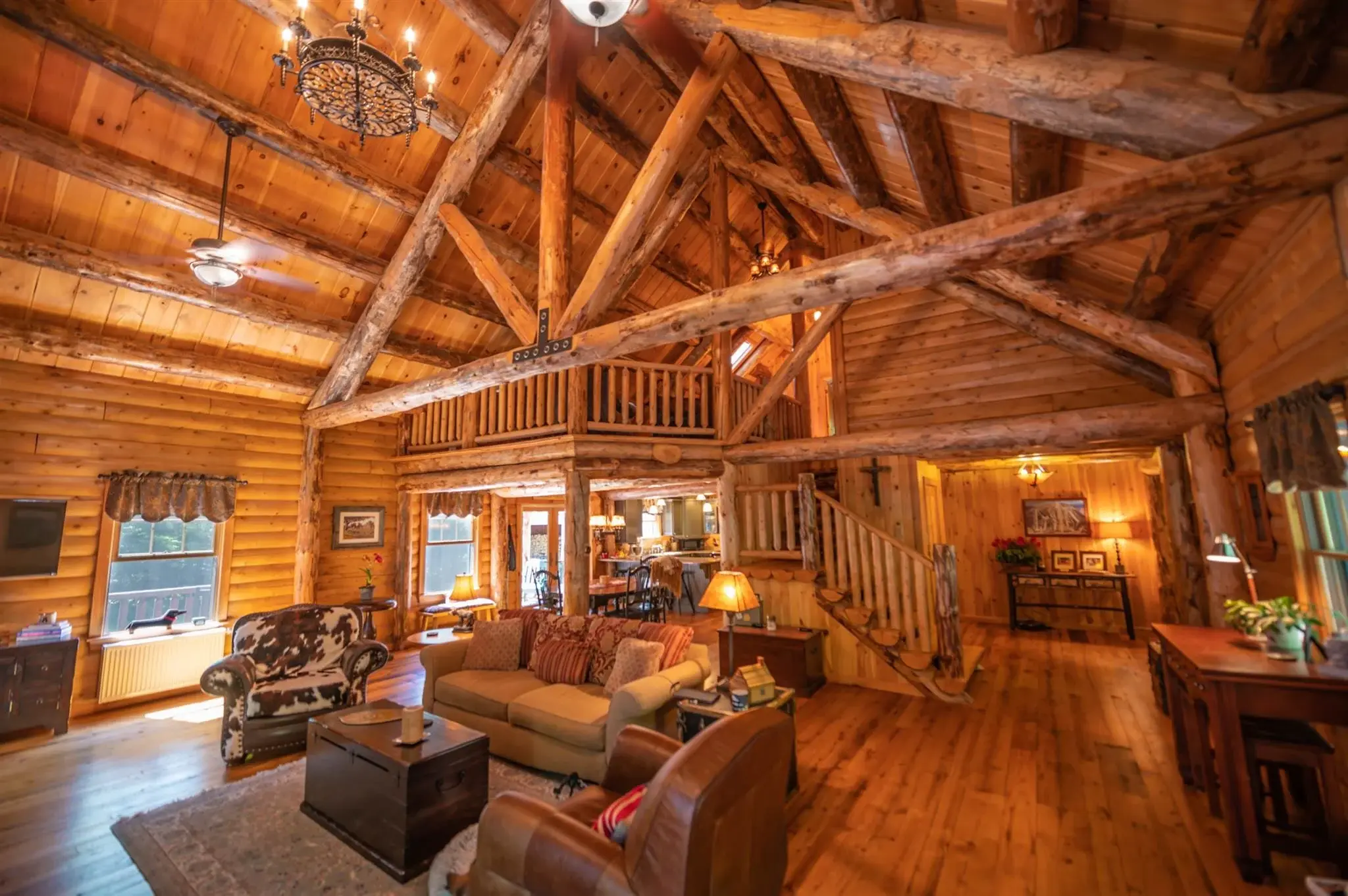 Based on the Mountaineer model, this open concept main floor utilizes an impressive central staircase as both a focal point and a practical way to separate the busy areas of the home like the kitchen and entryway from the relaxed sitting area. 