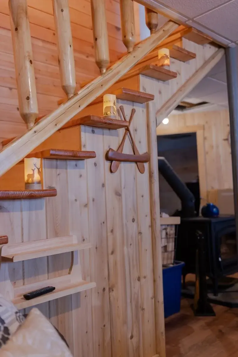 Stairs leading from the ground floor to the main level feature steps stained a darker shade for a striking contrast. 