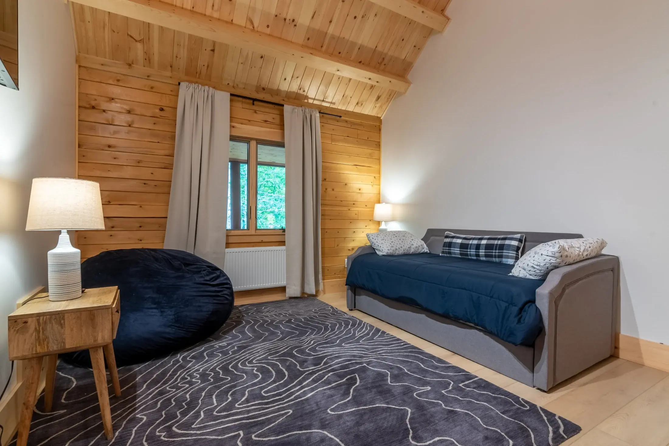 The loft is comfy and casual, but maintains a refined look by keeping the color palette simple.  Only navy, gray, and white are used throughout, so even mixing plaids, patterns, and textures feels cohesive. 