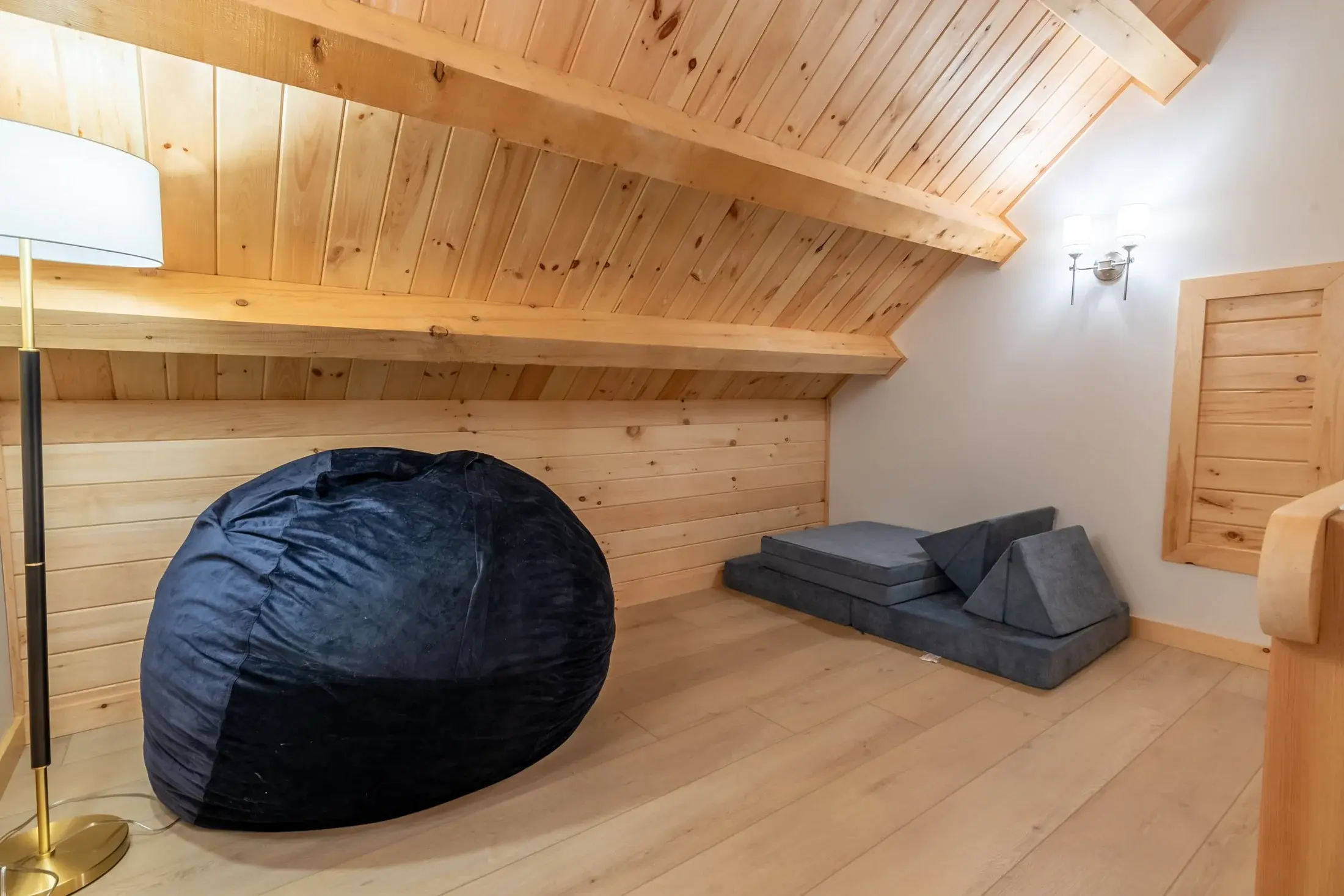 A loft is a classic feature of any log home, and the versatility of such a space is demonstrated here. Perfect for yoga, reading, or napping, the simple loft is a great use of space. 