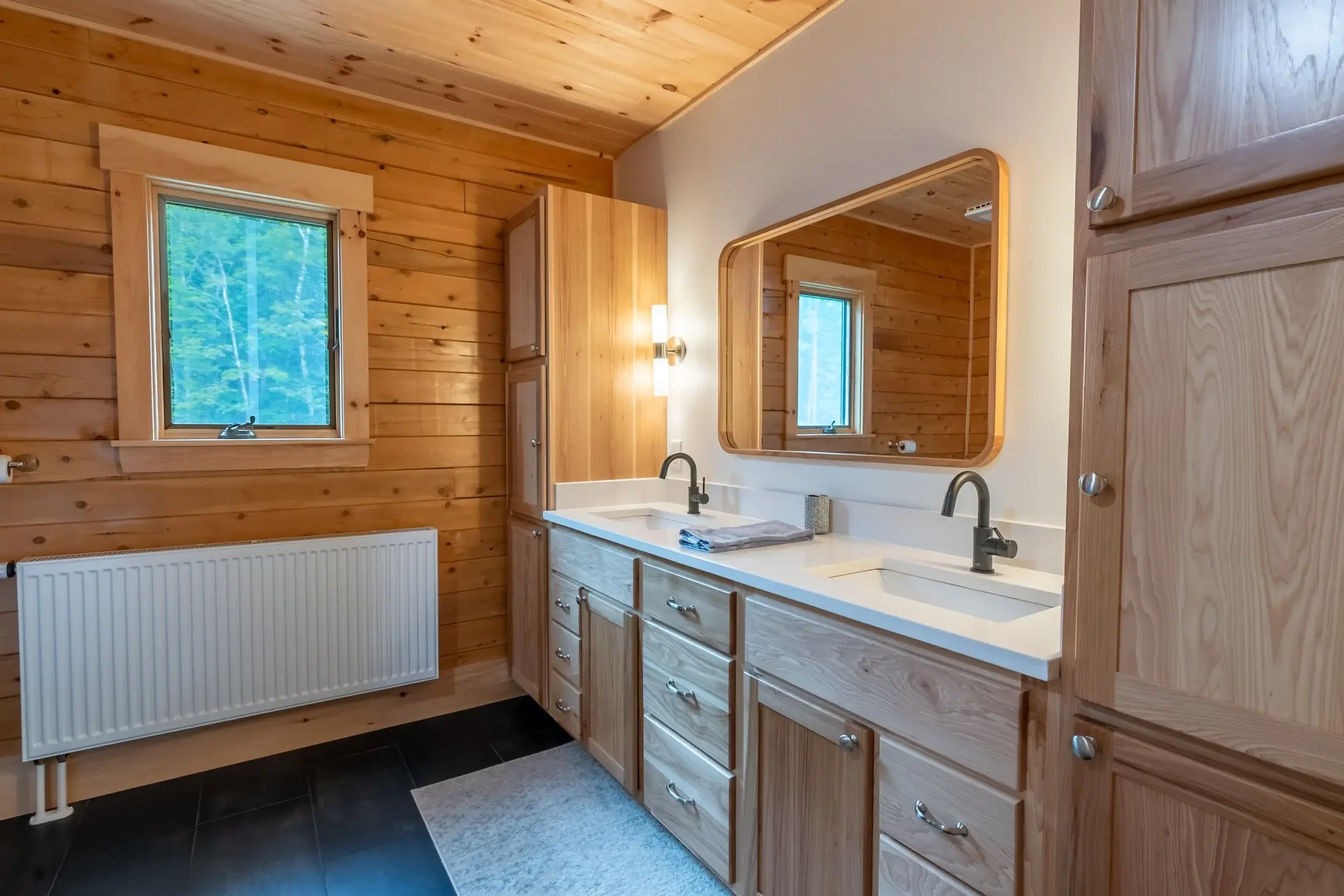 Unassuming white becomes an accent color when paired with natural wood, matte black metal, and dark stone tiles. 