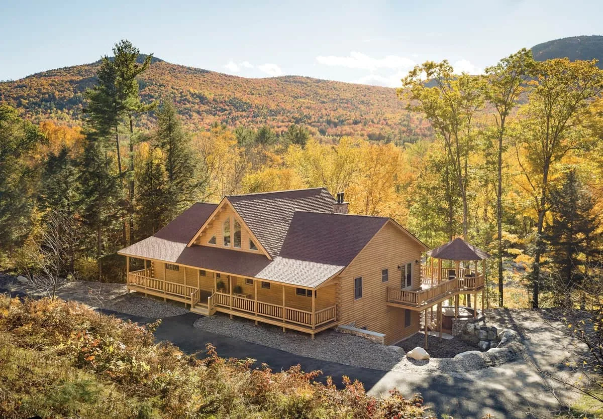 Exterior of multi level custom log home with mountain view