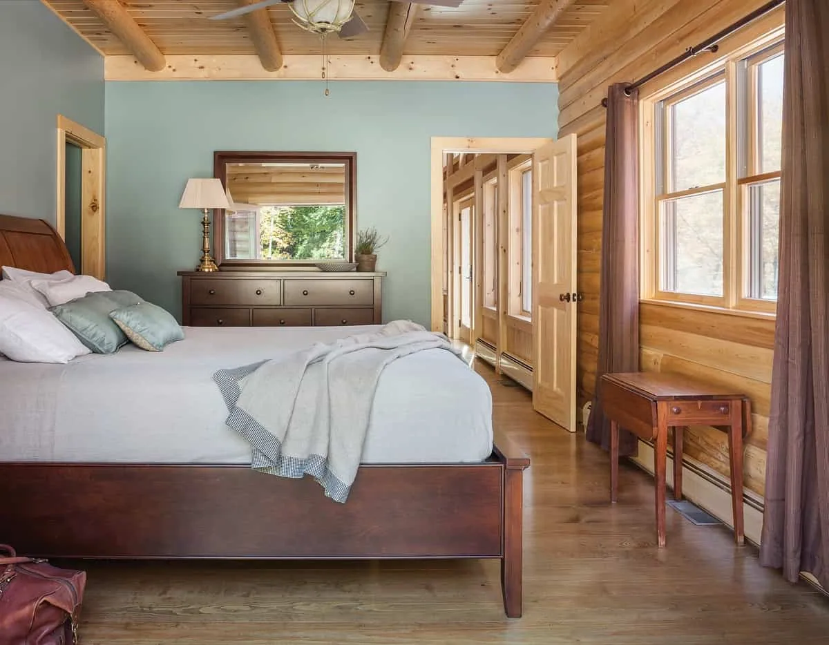 Master bedroom with interior painted blue walls and wooden ceiling