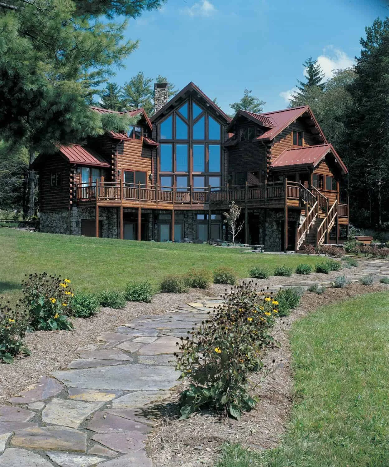 Exterior multi level custom cedar log home with full wall of glass. Contact Big Twig Homes LLC. for more details