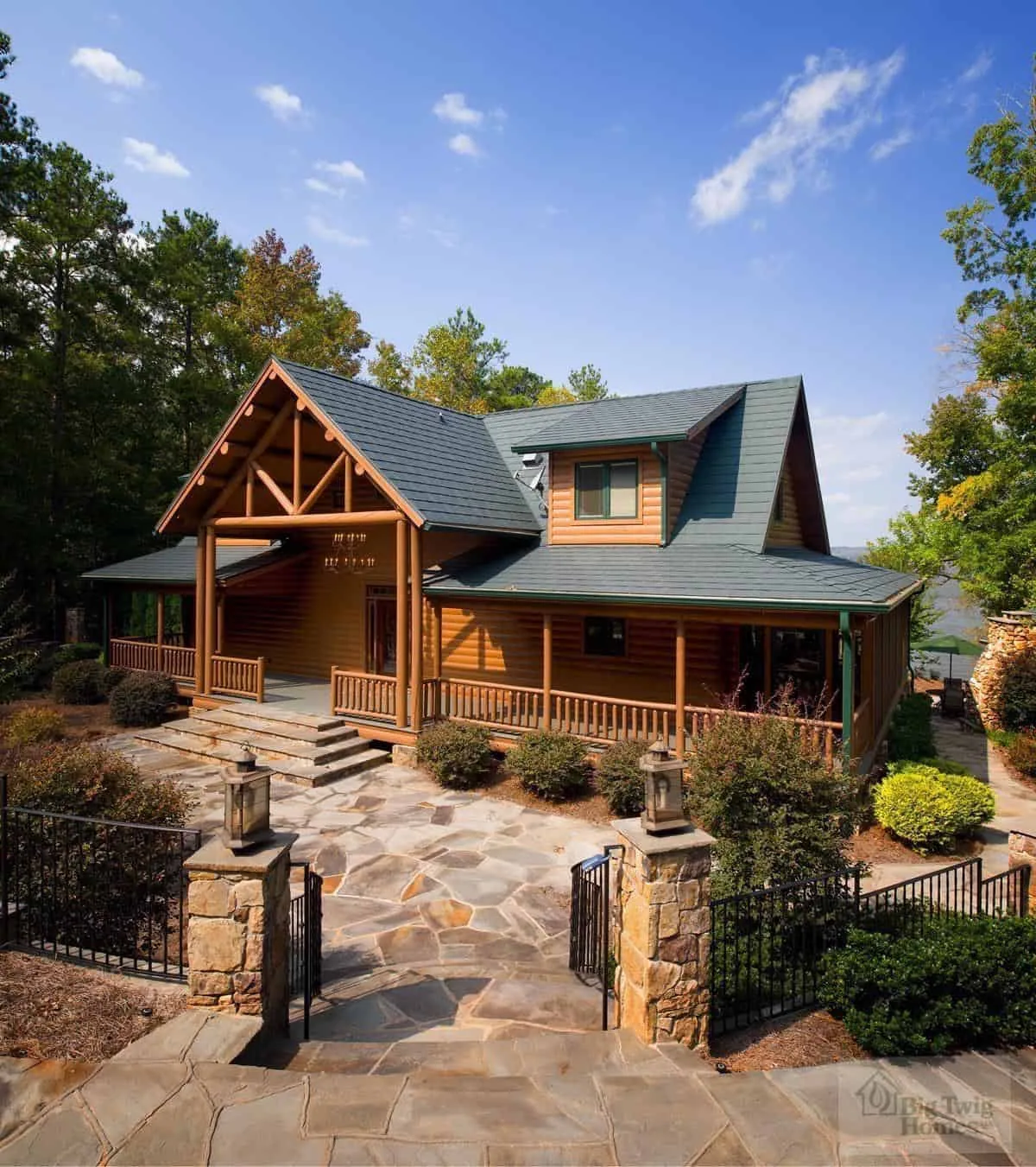 Big Twig Homes LLC. Beautiful cedar log home in the mountains on a lake. Picture of the exterior with lots of stone work. Big Twig Homes LLC. is a dealer of high quality cedar log homes, sell log home packages and log home kits, serving the Southeastern United States including North Carolina, South Carolina, Georgia, and Tennessee.