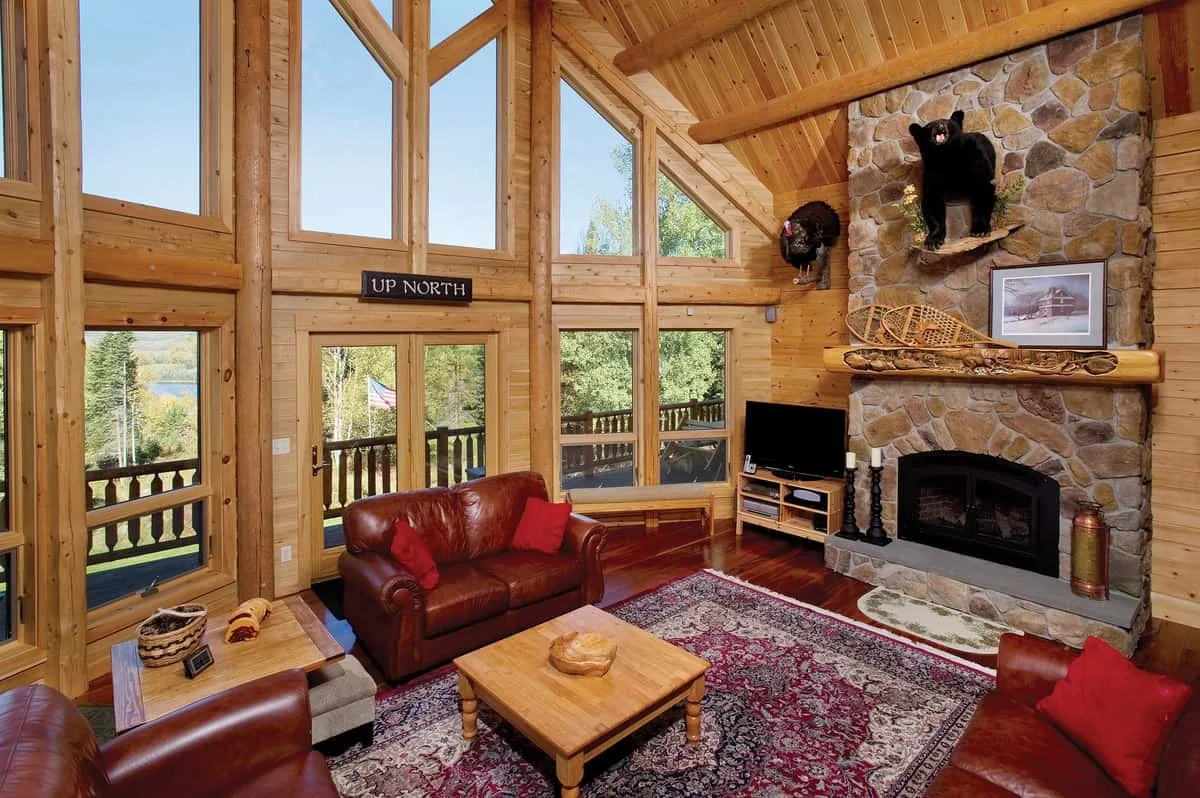 Big Twig Homes LLC. Beautiful cedar log home in the mountains. Picture of the interior great room with large fireplace, lots of glass in the home. Big Twig Homes LLC. is a dealer of high quality cedar log homes, sell log home packages and log home kits, serving the Southeastern United States including North Carolina, South Carolina, Georgia, and Tennessee.