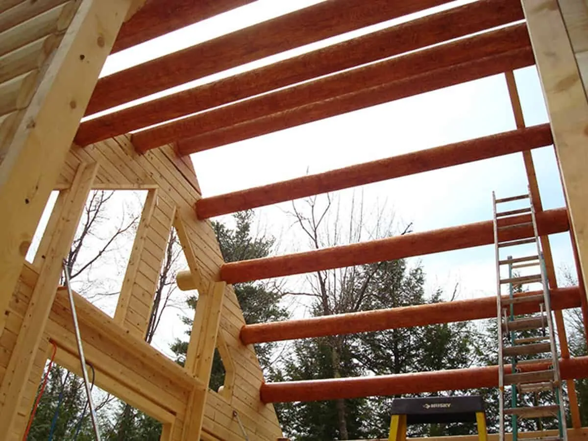 Large logs comprise the strong ceiling beams in this log cabin.