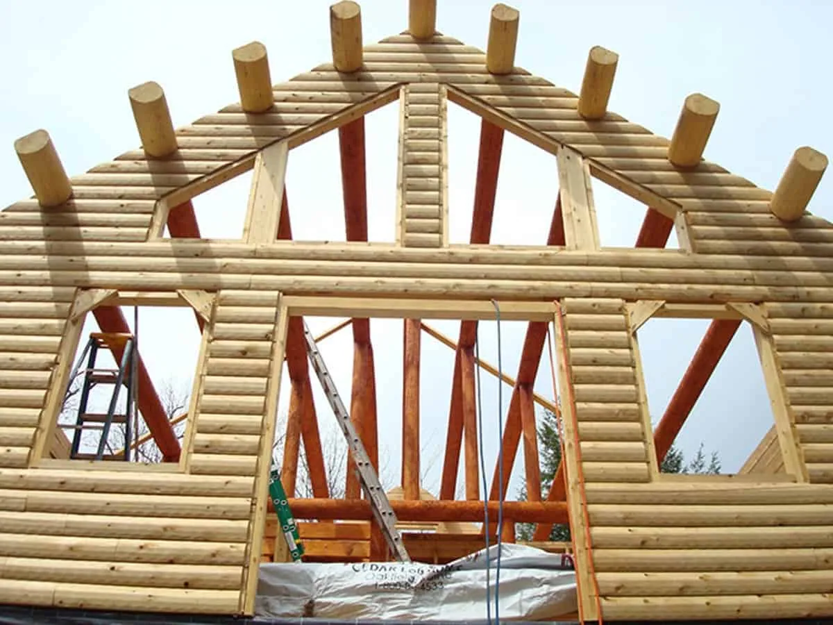 The ceiling beams hang over the wall to become the eaves for the roof.