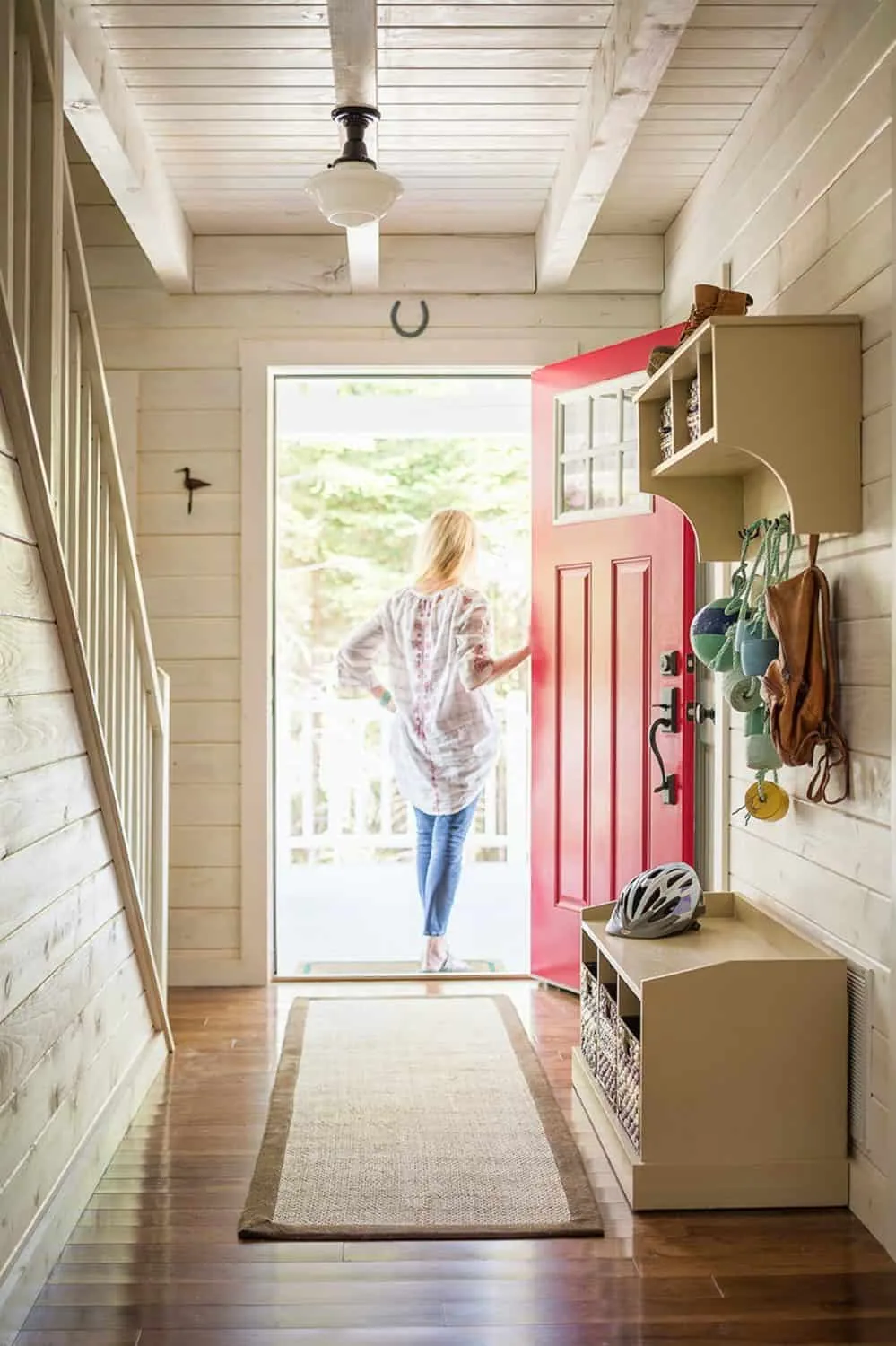 A woman standing in the doorway of her new home.