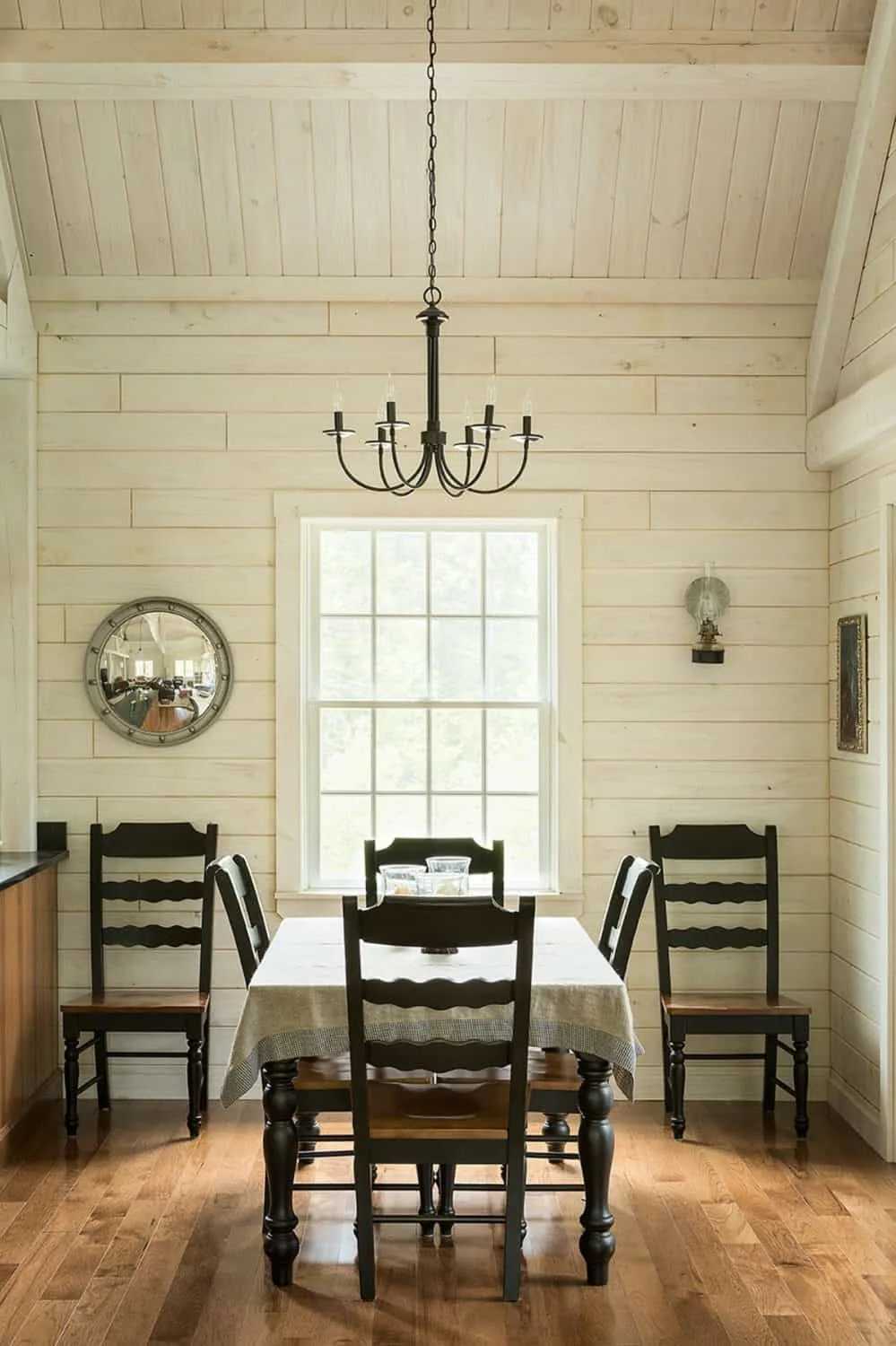 A modest chandelier over a dining table.