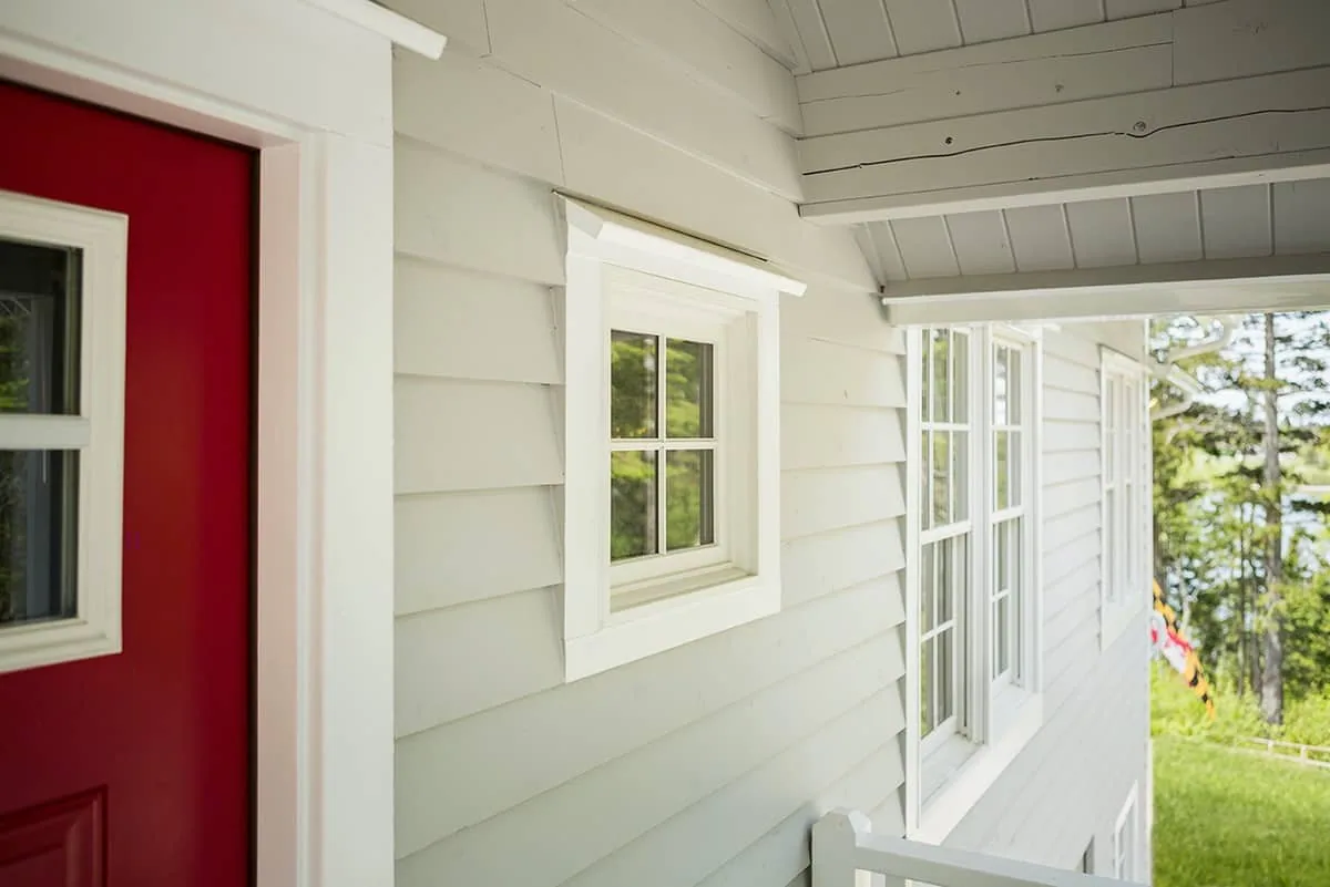 A small picture window by the front door.